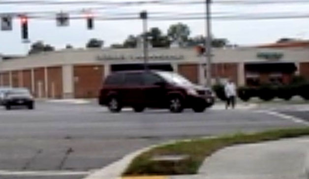 3 photos show Dona starting to cross with parallel street on her right, and vehicles are moving forward from the parallel street on her right and turning left in front of her.  The first vehicle approaches her and cuts in front of her.